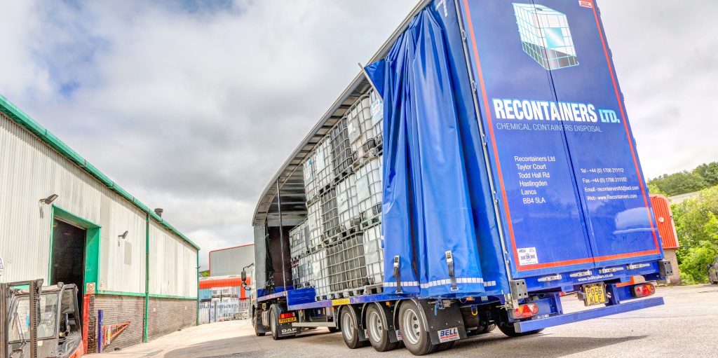 Securely stacked IBCs ready for liquid transport on a flatbed truck